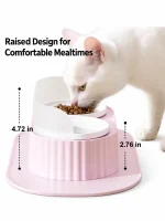 White cat eating from a pink raised slanted cat bowl
